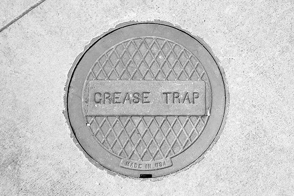 foul odors, slow drainage, and grease accumulation are all signs that your grease trap needs pumping