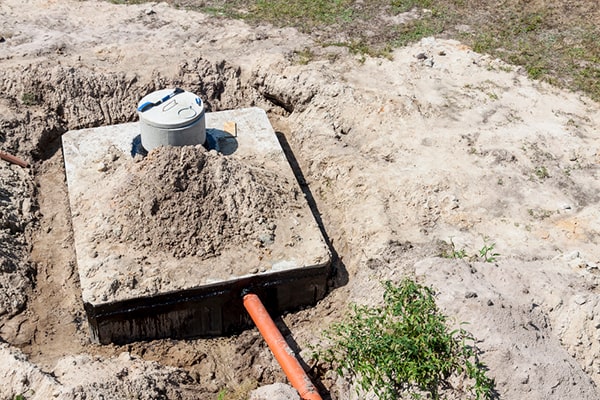 septic tank pumping involves removing the sludge and scum from the tank using a vacuum truck